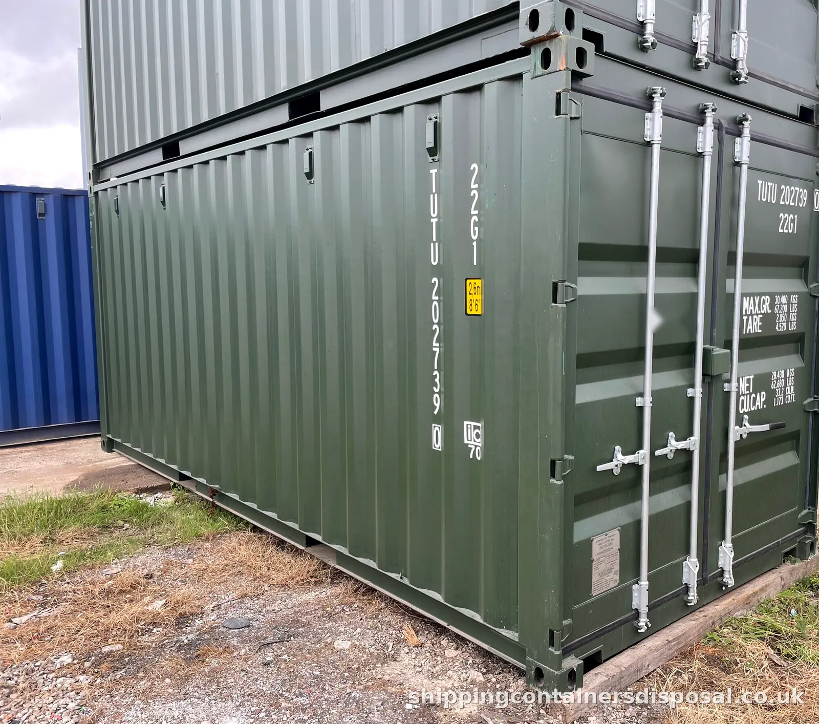 Two green 20ft shipping containers stacked Two green 20ft shipping containers stacked