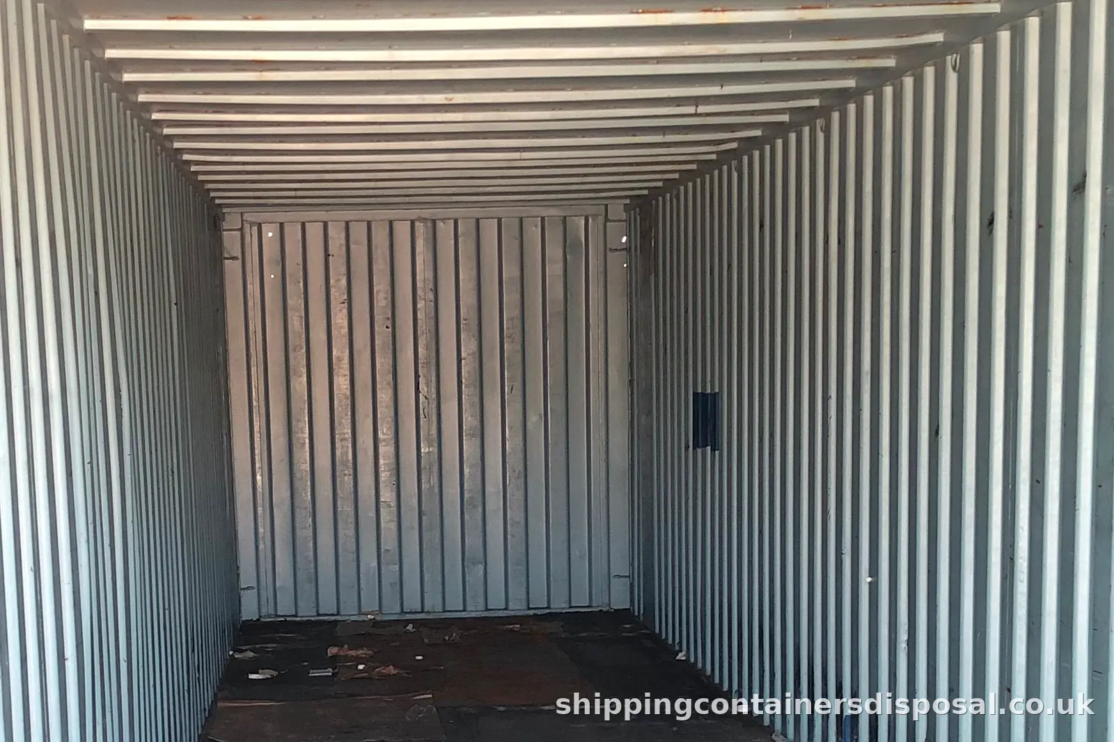 Part of the inside of a long empty shipping container Part of the inside of a long empty shipping container