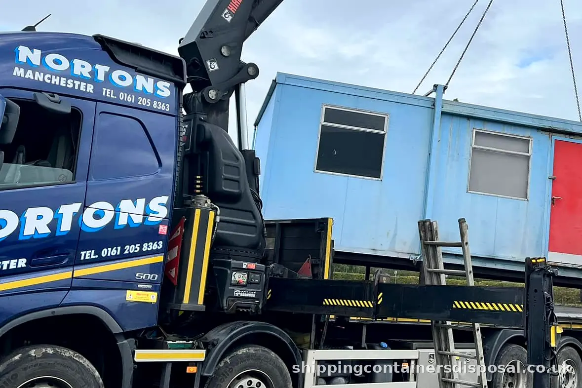 Detail of a HIAB lorry lifting a blue portable cabin Detail of a HIAB lorry lifting a blue portable cabin