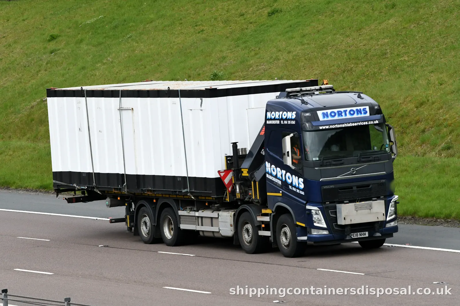 Volvo HIAB lorry carrying a white site unit