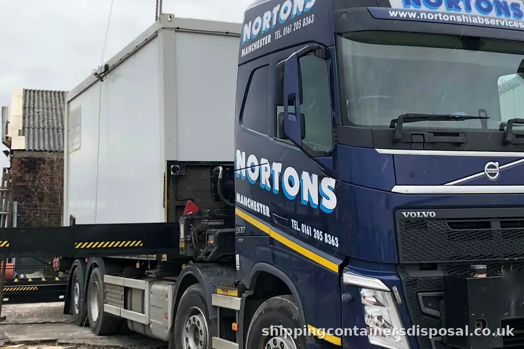 A HIAB lorry lifting a cabin with its stabiliser legs down A HIAB lorry lifting a cabin with its stabiliser legs down