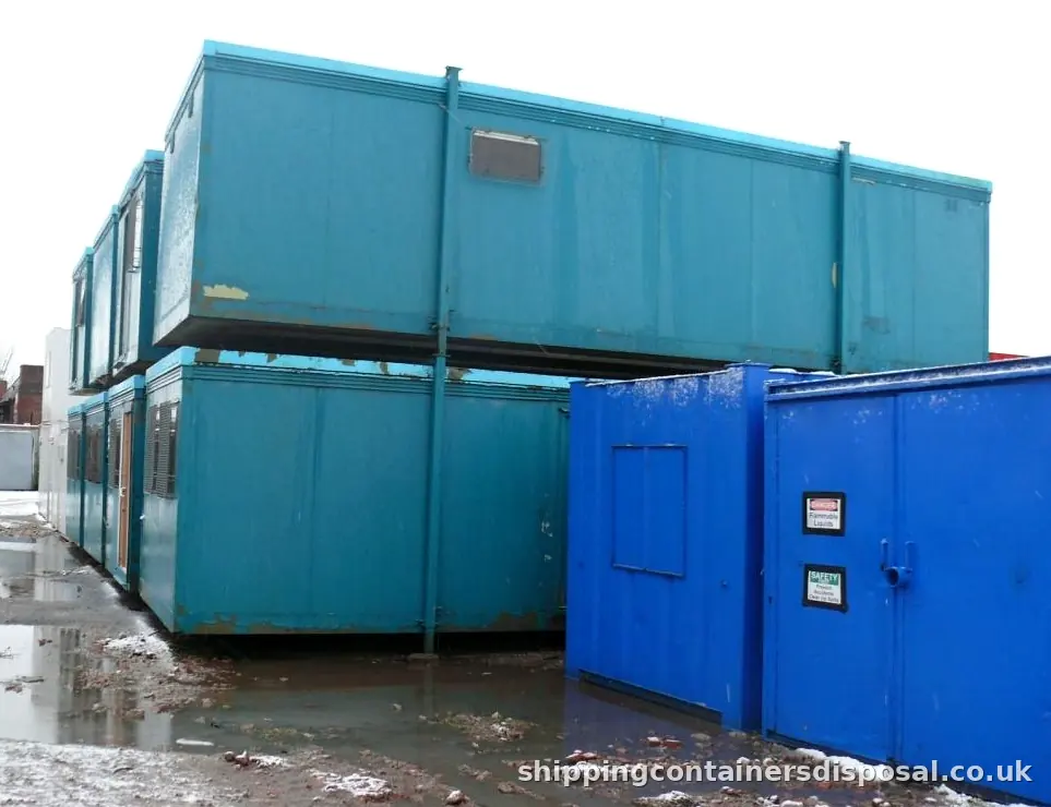 Stacked blue portable cabins and steel units Stacked blue portable cabins and steel units