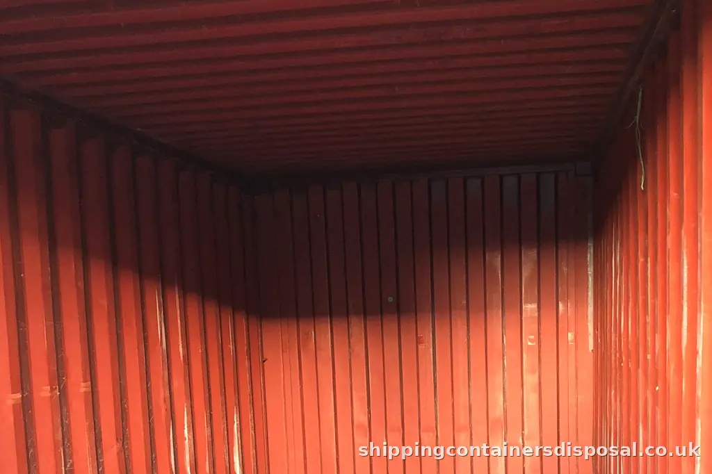 Wider view of the worn interior of a red shipping container Wider view of the worn interior of a red shipping container